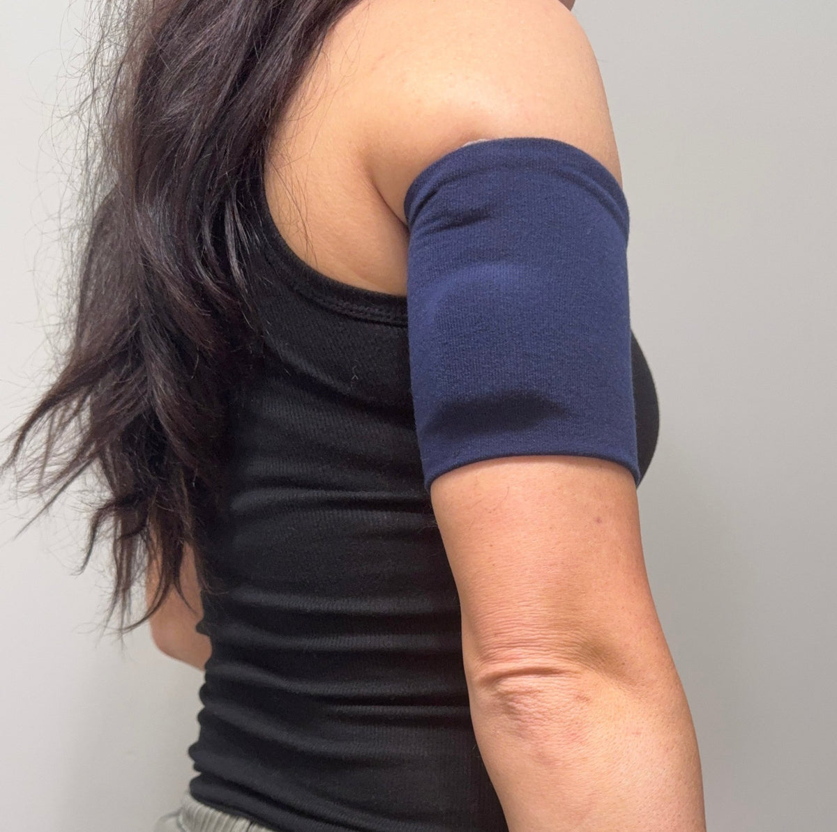 Cozy pod band in Blue Navy worn on the upper arm over a pod