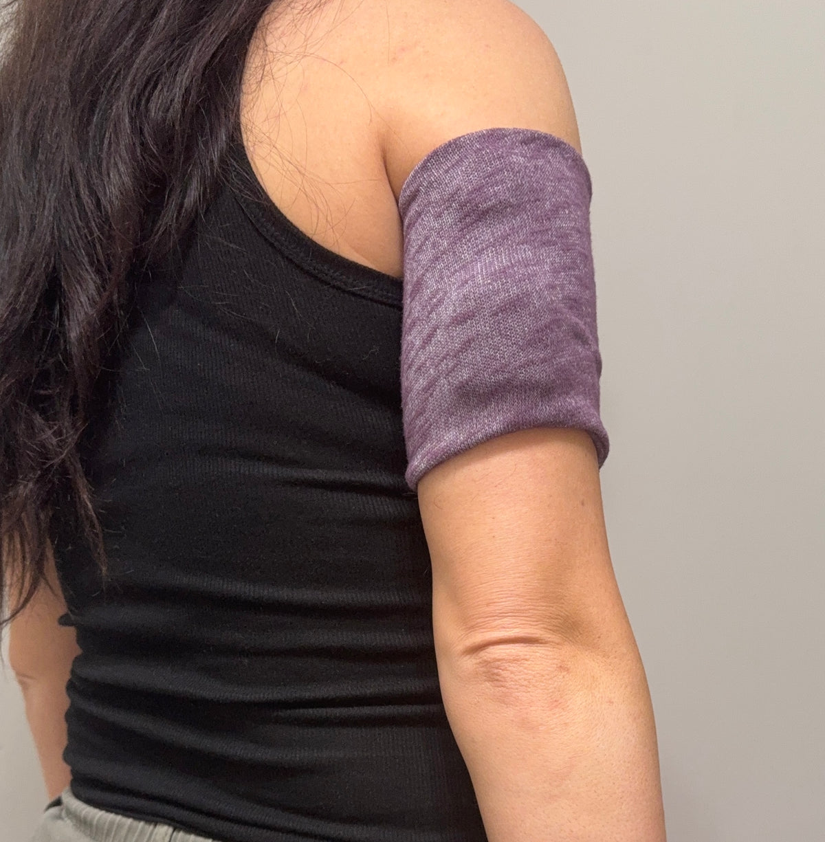 Cozy pod band in Purple worn on the upper arm over a pod
