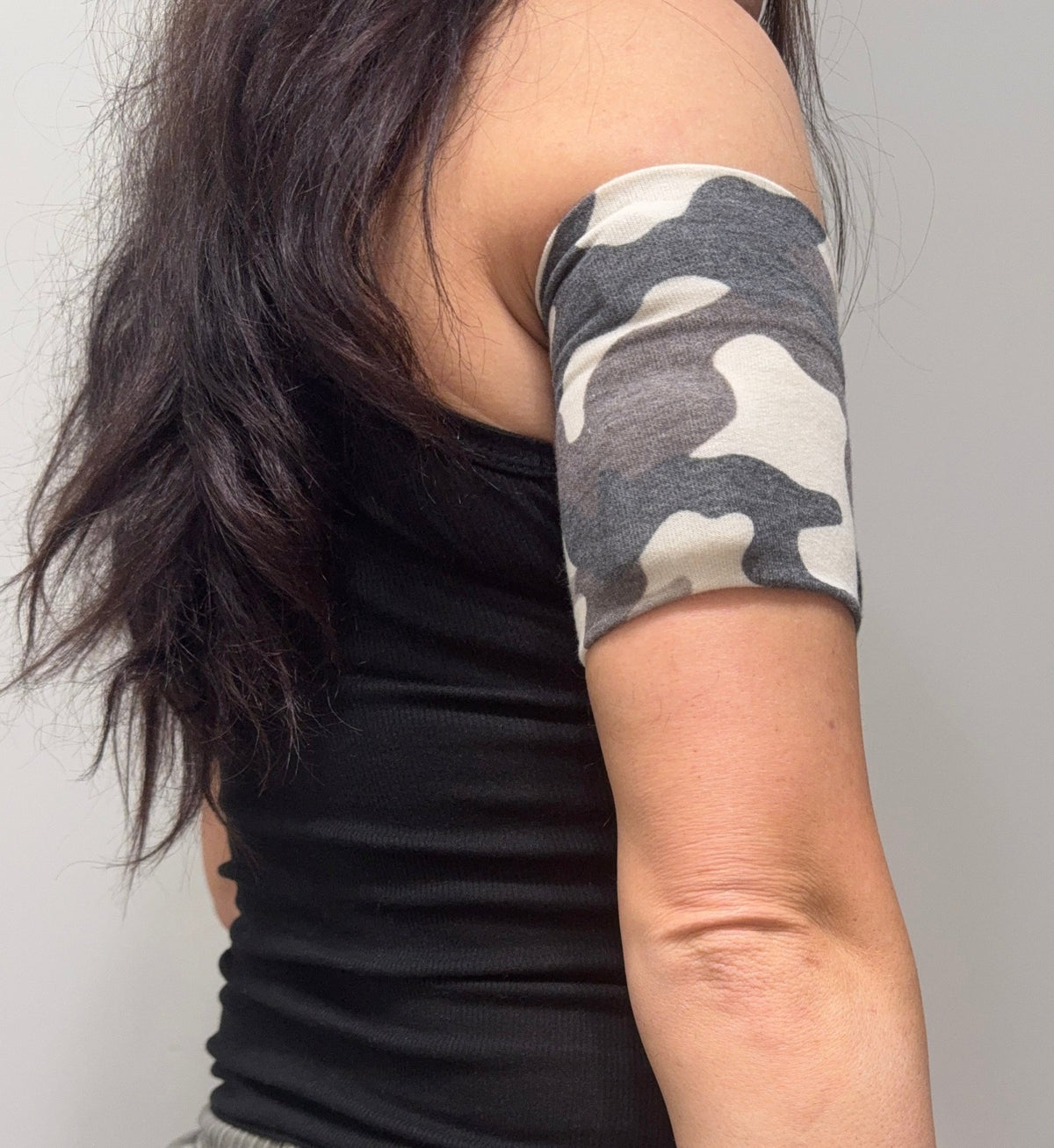 Cozy pod band in Tan Camo, brown and cream camouflage, worn on the upper arm over a pod