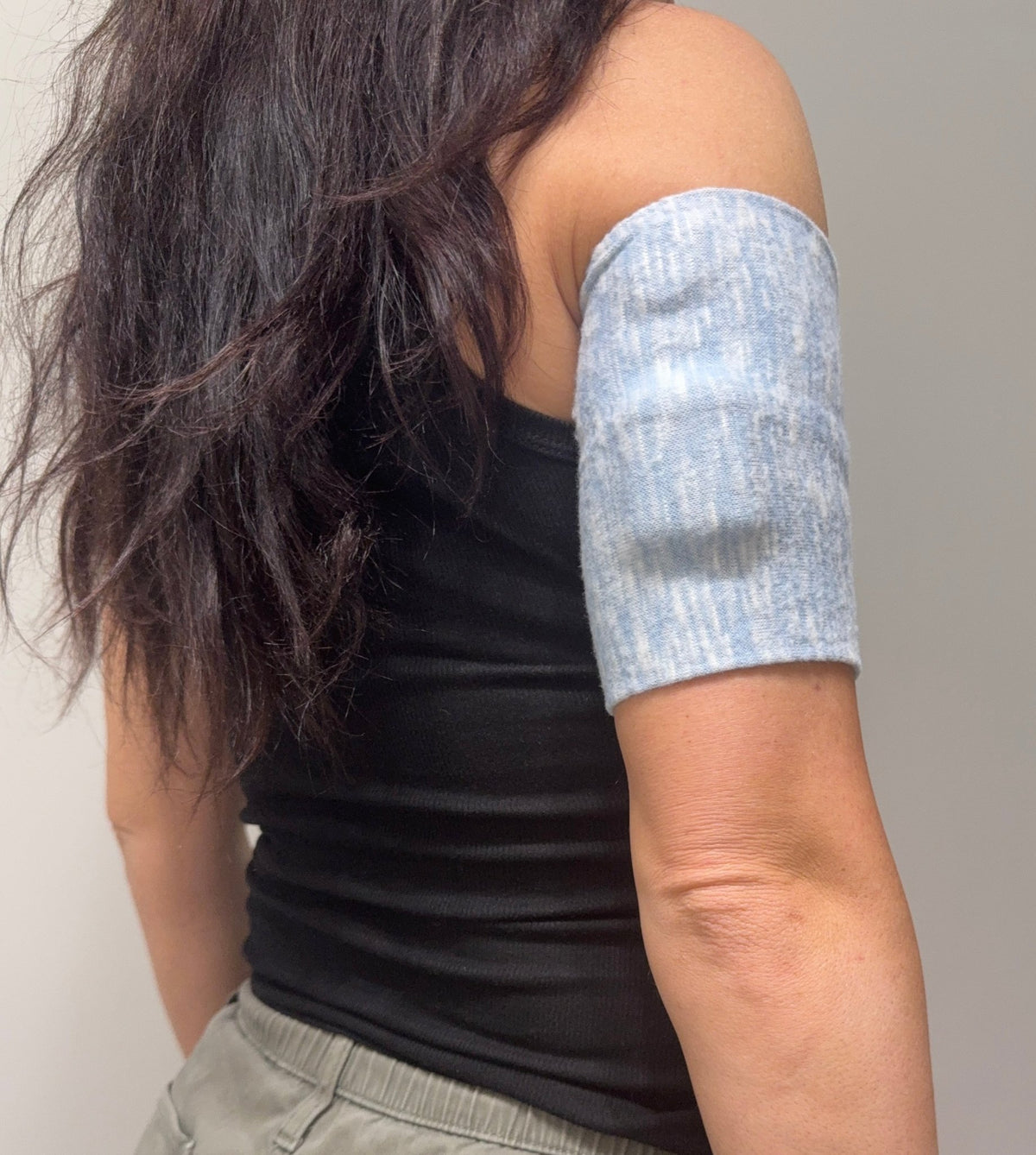 Cozy pod band in Blue Heather worn on the upper arm over a pod