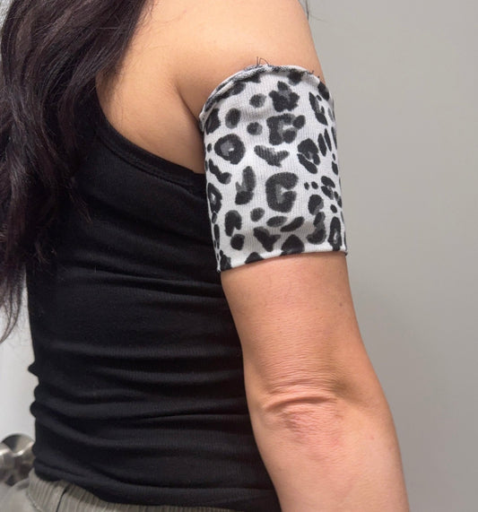Cozy pod band in White & Black Cheetah worn on the upper arm over a pod