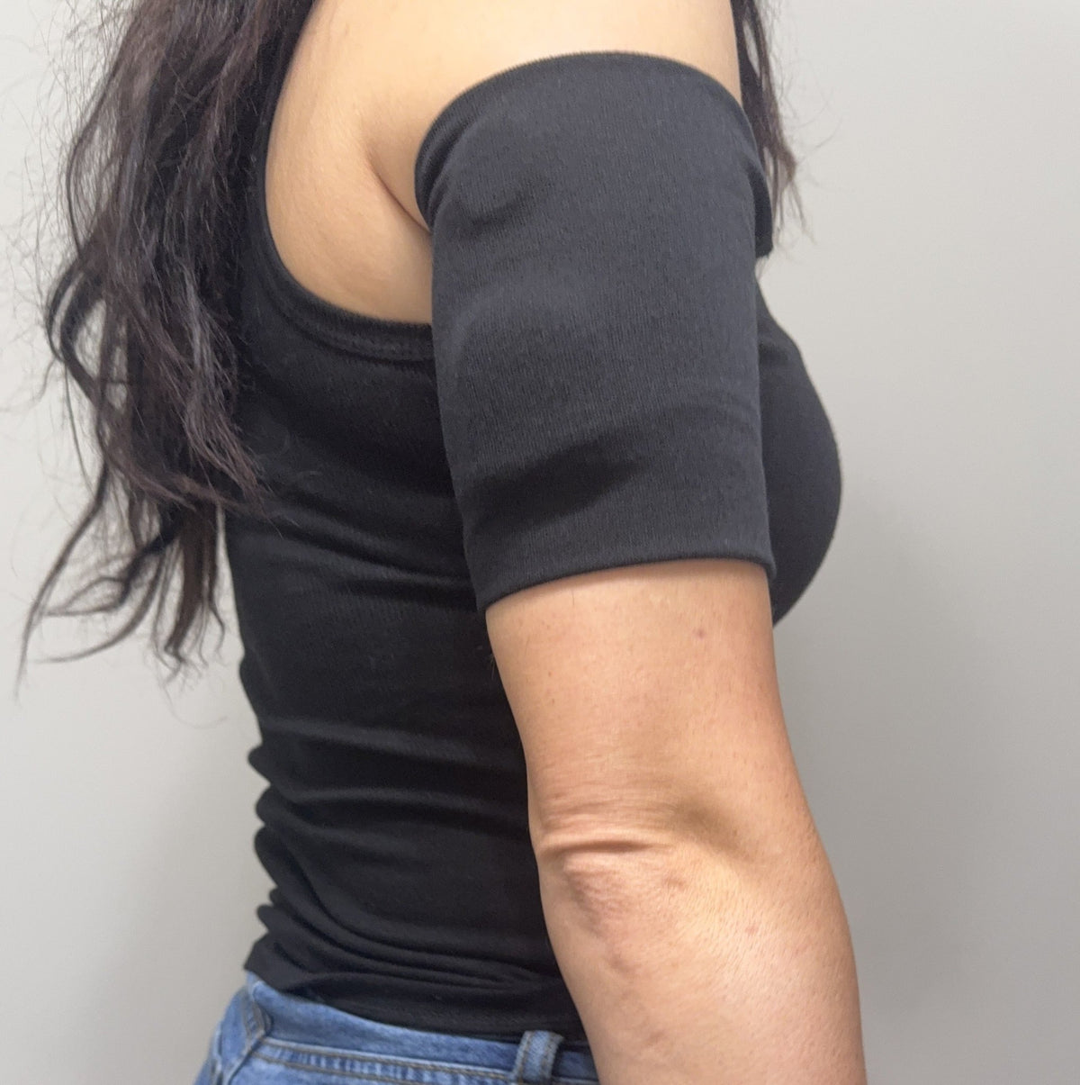 Black textured pod band worn on the upper arm over a pod