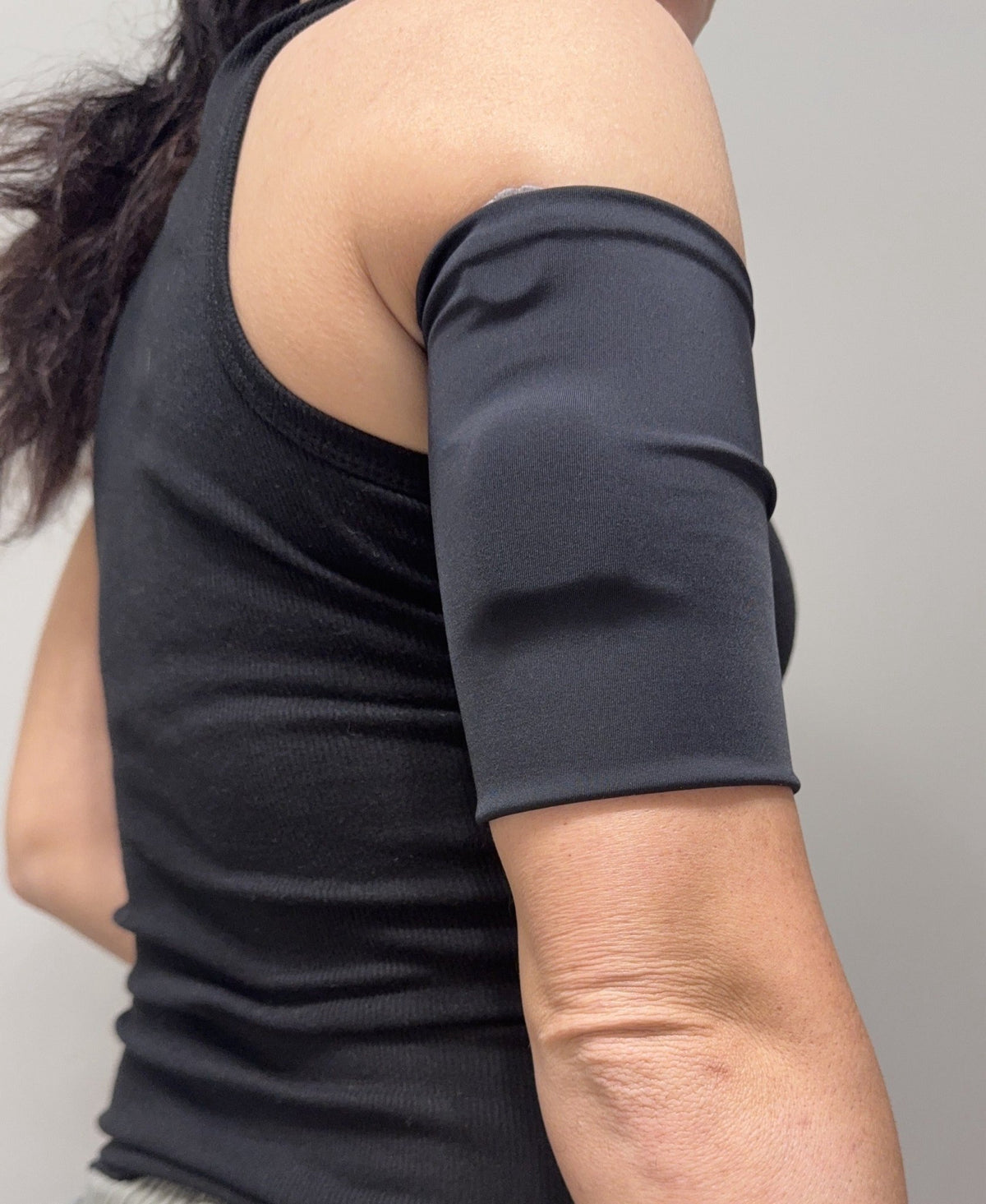 Sport pod band in Black worn on the upper arm over a pod